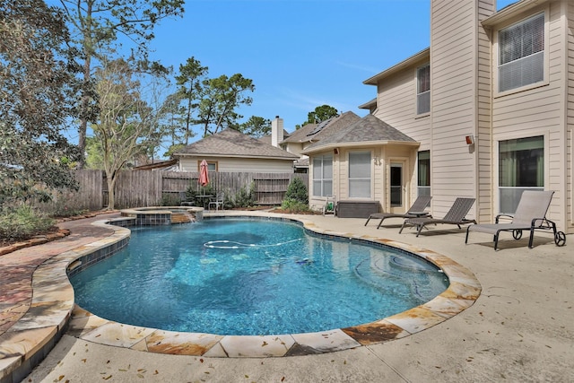 view of pool featuring a patio area, a fenced backyard, and a pool with connected hot tub