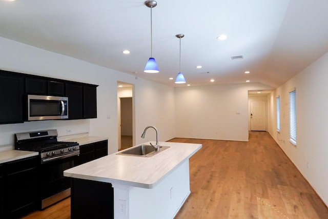 14428 Sugar Pines Dr, Conroe, TX 77302 - kitchen featuring a sink, light countertops, dark cabinetry, and stainless steel appliances