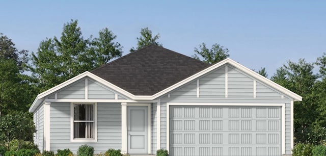 view of front of property featuring a shingled roof and a garage