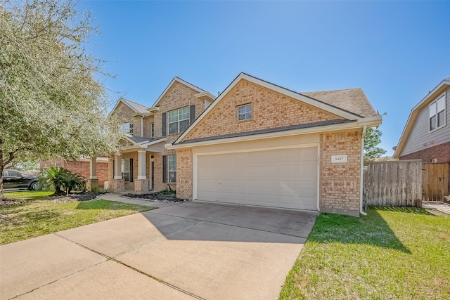 view of front of home with a front yard, brick siding, fence, and an attached garage