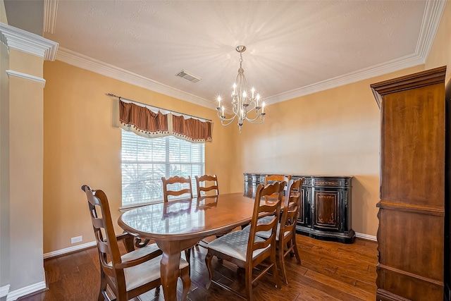 dining room with crown molding, visible vents, and wood finished floors