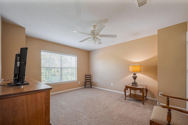 unfurnished room featuring light carpet, baseboards, visible vents, a ceiling fan, and a textured ceiling