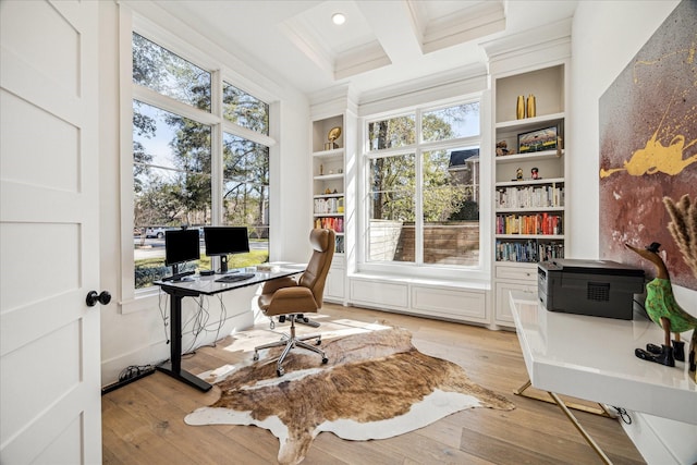 home office with built in shelves, crown molding, light wood-style floors, coffered ceiling, and beamed ceiling