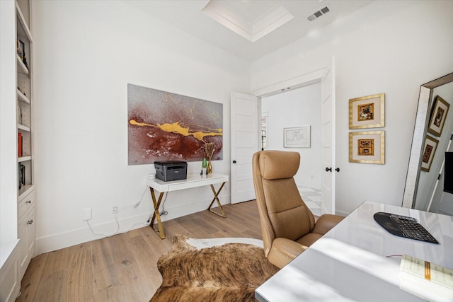 home office featuring wood finished floors, visible vents, and baseboards