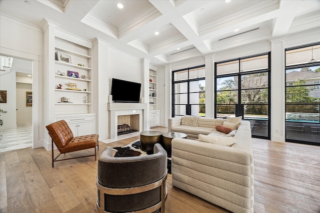 living room with light wood-style floors, coffered ceiling, beamed ceiling, and built in shelves