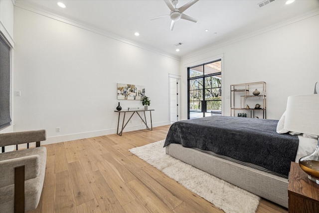 bedroom with light wood-style floors, baseboards, crown molding, and recessed lighting