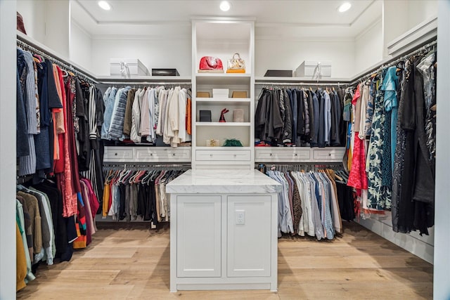 walk in closet with light wood-type flooring