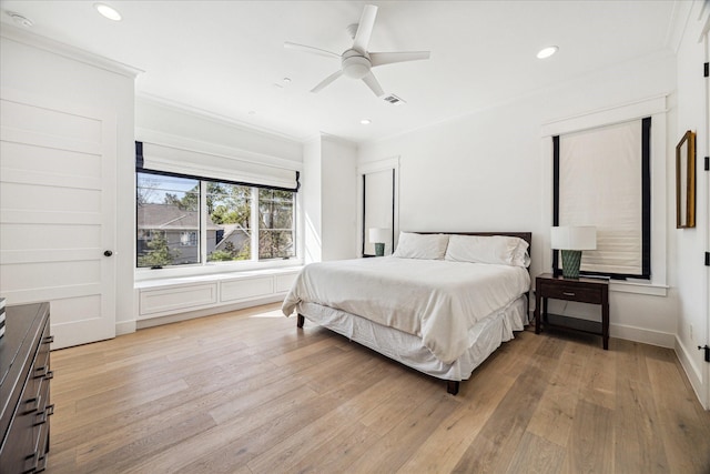 bedroom featuring light wood-style floors, crown molding, and recessed lighting