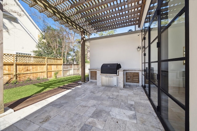 view of patio with area for grilling, grilling area, fence, and a pergola