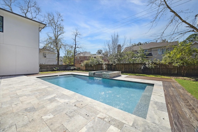 view of pool featuring a patio area, a fenced backyard, and a pool with connected hot tub