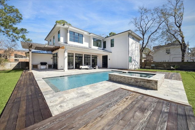 rear view of property with stucco siding, a fenced backyard, a deck, and a pergola