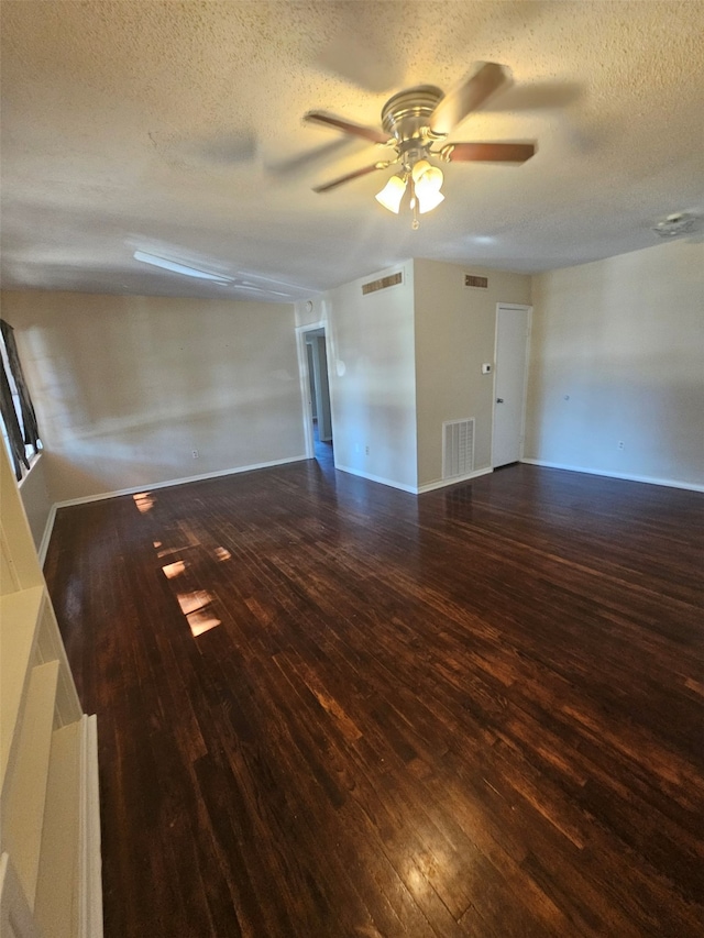 unfurnished room featuring a ceiling fan, wood finished floors, and visible vents