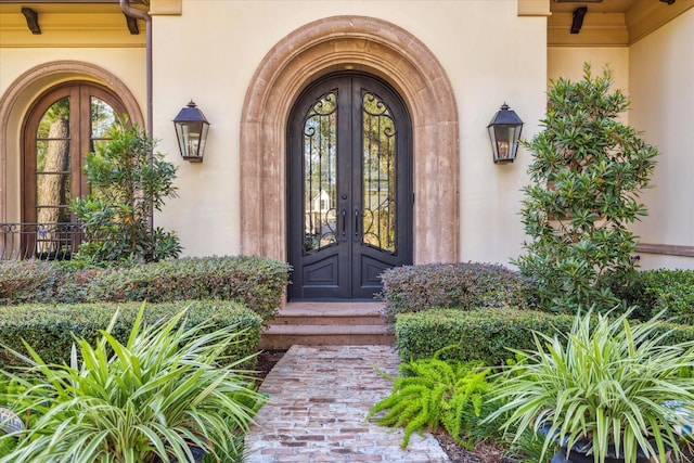 doorway to property with french doors and stucco siding