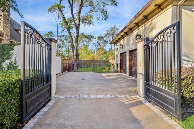 view of gate featuring a patio area and fence