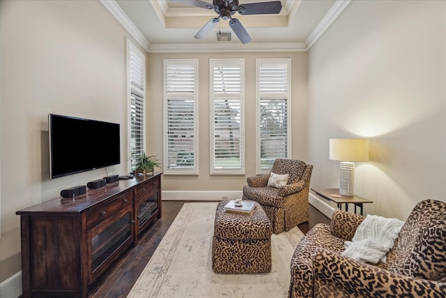 sitting room featuring a ceiling fan, baseboards, wood finished floors, visible vents, and ornamental molding