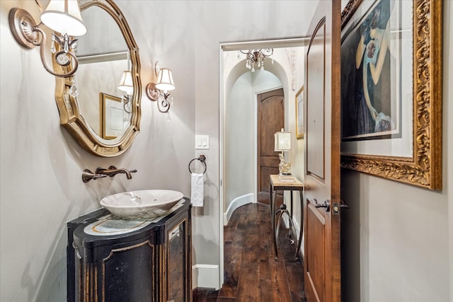 bathroom featuring vanity, baseboards, and wood finished floors