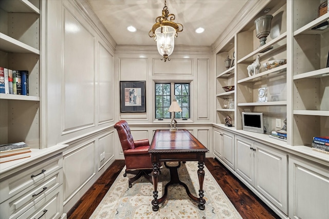 office area featuring dark wood-type flooring, a chandelier, and a decorative wall