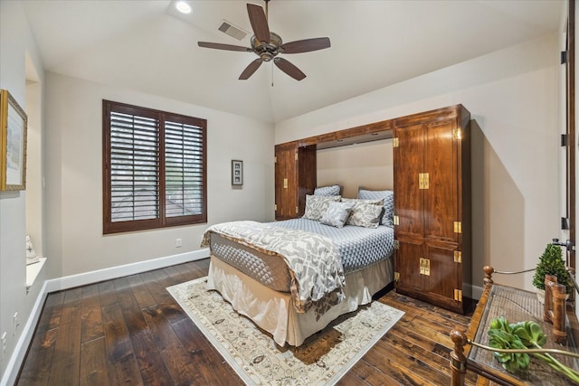 bedroom with lofted ceiling, baseboards, dark wood-style flooring, and visible vents