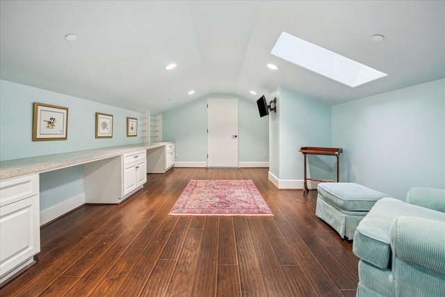 unfurnished office featuring lofted ceiling with skylight, dark wood finished floors, recessed lighting, baseboards, and built in study area