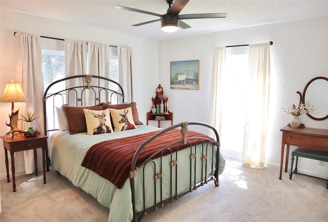 bedroom with carpet, a textured wall, and ceiling fan