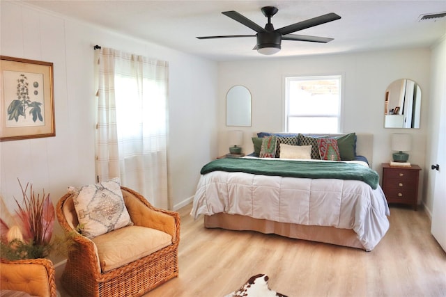 bedroom featuring visible vents, a ceiling fan, and light wood-style floors