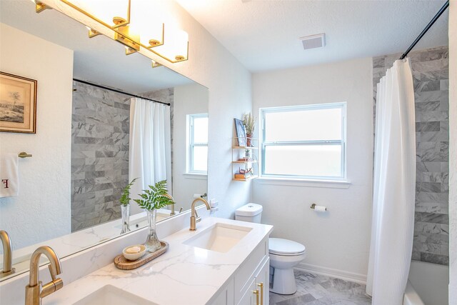 bathroom featuring visible vents, toilet, marble finish floor, a textured ceiling, and vanity