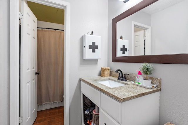 bathroom featuring vanity and wood finished floors