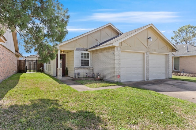 view of front of house with brick siding, concrete driveway, fence, a garage, and a front lawn