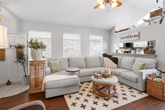 living room with vaulted ceiling, dark wood finished floors, and ceiling fan