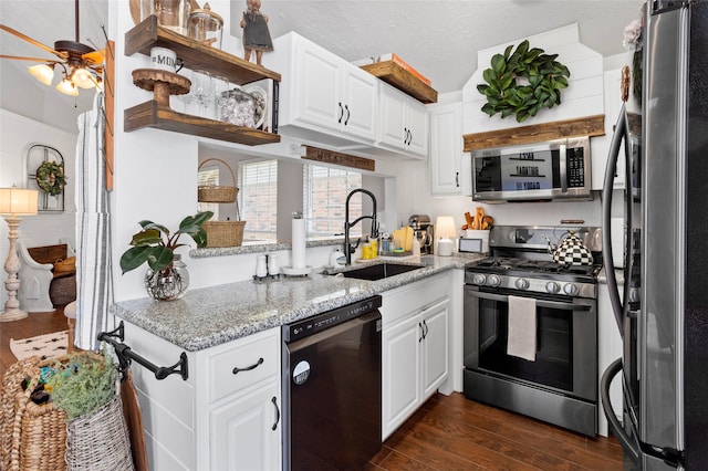 kitchen with open shelves, dark wood finished floors, stainless steel appliances, and a sink