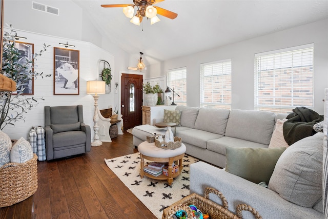 living room featuring dark wood-style floors, visible vents, ceiling fan, and high vaulted ceiling