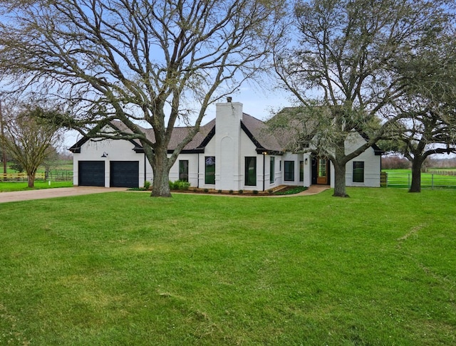 view of front of property featuring a garage, concrete driveway, a front lawn, and fence