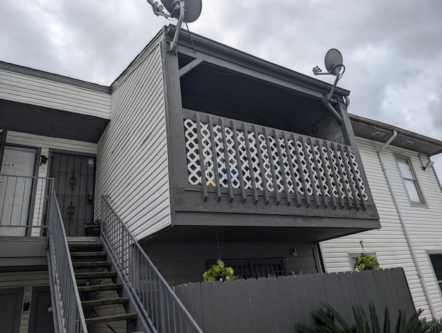 view of side of property with stairs and fence