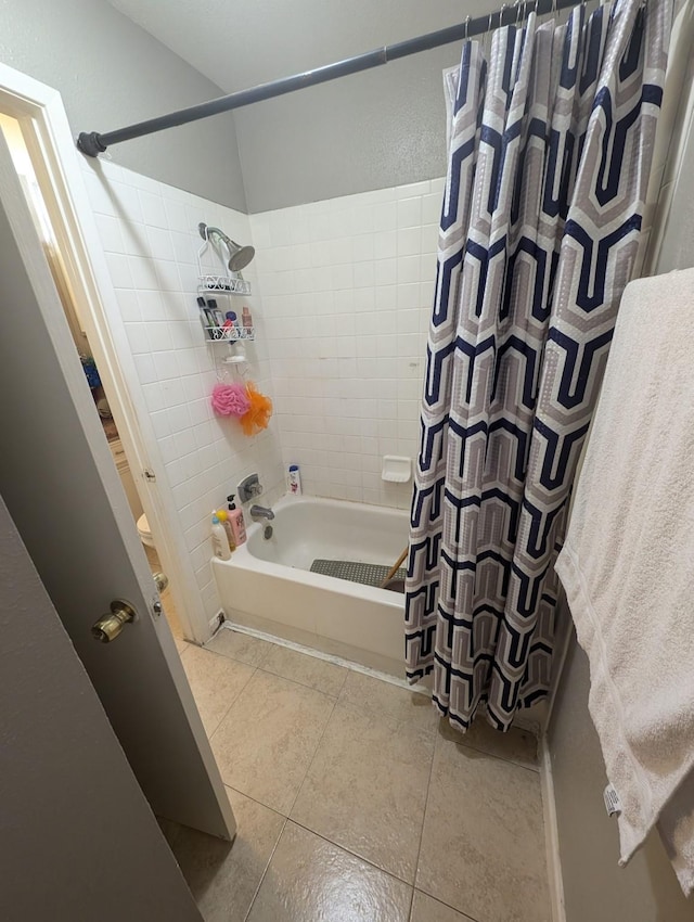 bathroom featuring shower / bath combination with curtain and tile patterned floors