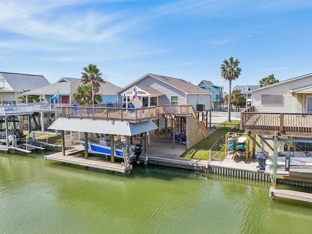 dock area featuring a residential view, a deck with water view, boat lift, and stairs