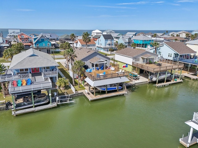 birds eye view of property with a water view and a residential view