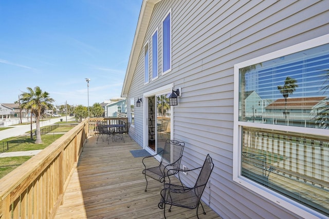 wooden terrace with outdoor dining space