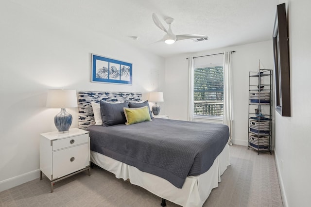 bedroom with a ceiling fan, light colored carpet, visible vents, and baseboards