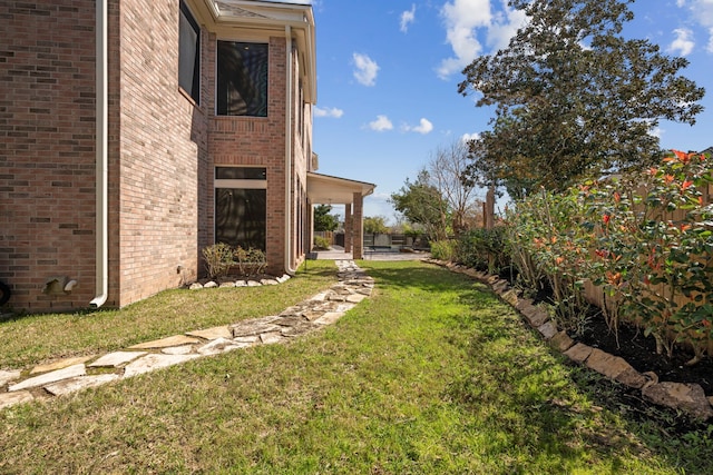 view of yard featuring a patio and fence