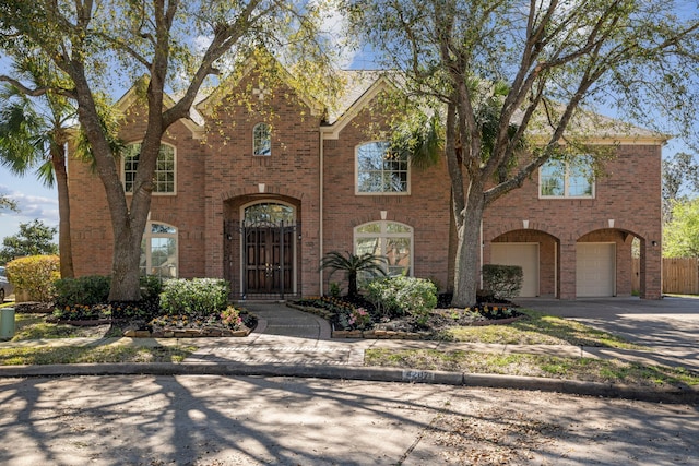 view of front of home with a garage, brick siding, and concrete driveway