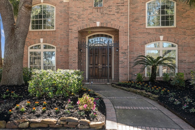 view of exterior entry with brick siding