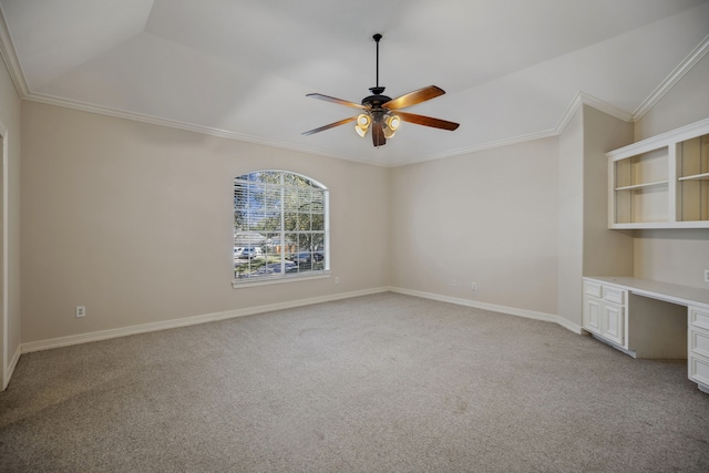 unfurnished room with ceiling fan, light carpet, ornamental molding, and built in study area