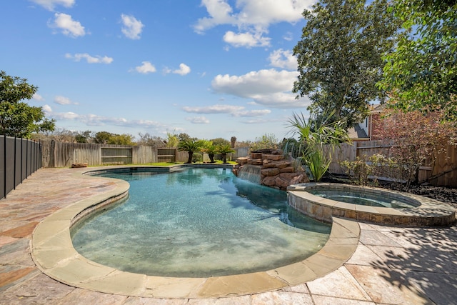 view of pool featuring a fenced backyard and a pool with connected hot tub