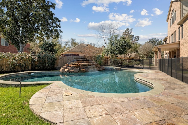 view of pool featuring a pool with connected hot tub, fence private yard, and a patio area