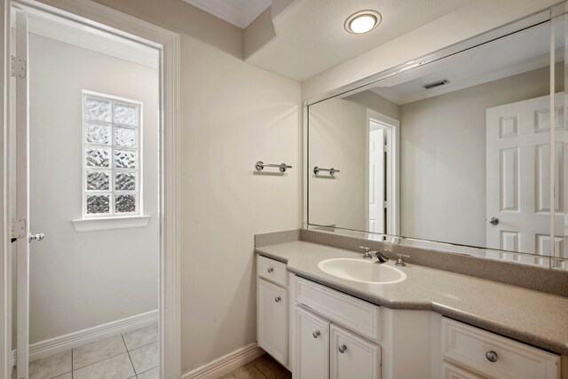 bathroom with tile patterned flooring, visible vents, vanity, and baseboards