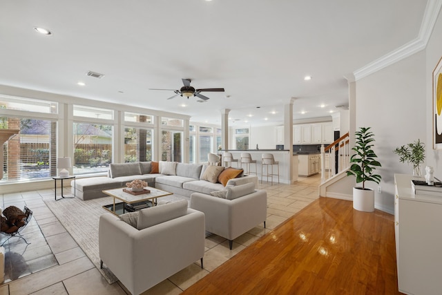 living room with visible vents, ornate columns, recessed lighting, ceiling fan, and crown molding