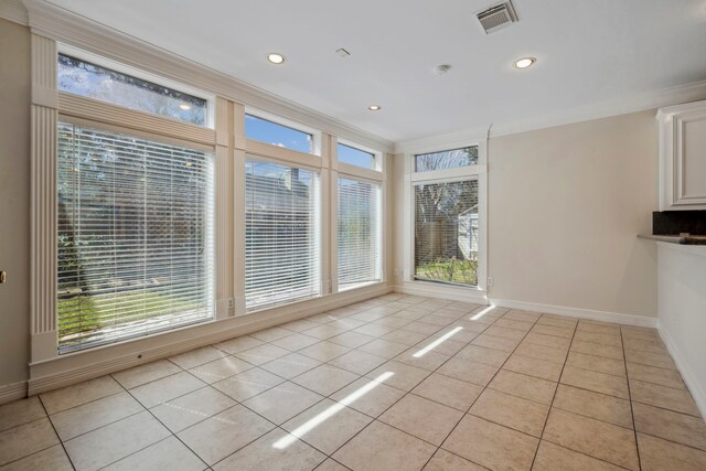 unfurnished dining area featuring light tile patterned floors, visible vents, and ornamental molding