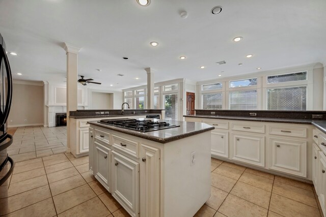 kitchen with a kitchen island, ceiling fan, decorative columns, recessed lighting, and light tile patterned flooring