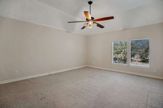 spare room with crown molding, baseboards, carpet floors, and ceiling fan