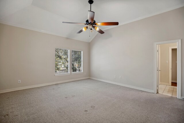 tiled spare room featuring crown molding, baseboards, lofted ceiling, and carpet